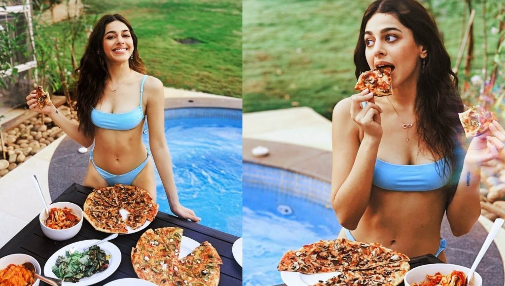 alaya furniturewalla latest blue bikini eating pizza photo