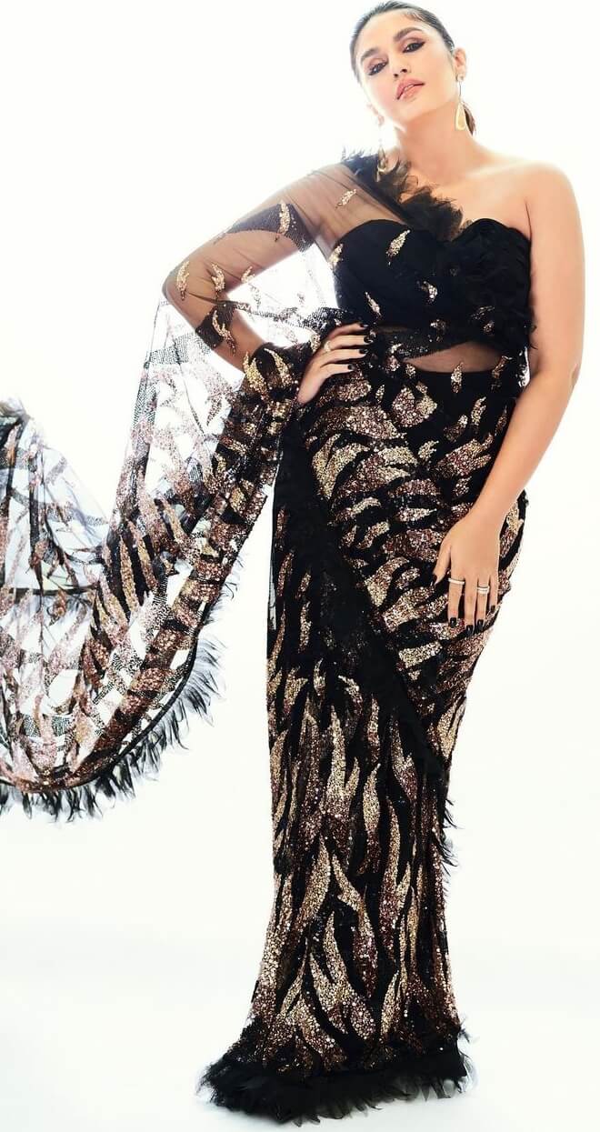 huma qureshi in a sexy black see through saree by designer abu jani sandeep khosla
